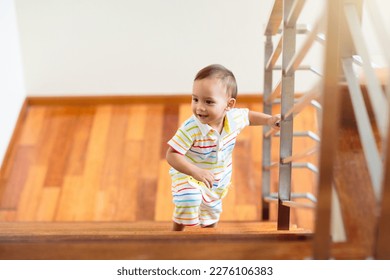 Kid walking stairs in white house. Asian baby boy playing in sunny staircase. Home safety for toddler. Family moving into new home. Child crawling steps of stairway. Foyer or living room interior.  - Powered by Shutterstock