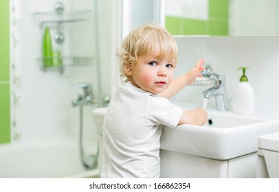 Kid Washing Hands In Bathroom
