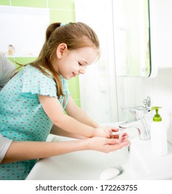 Kid Washing Hands With Mom
