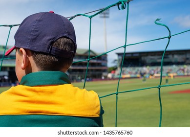 Kid Watching Cricket Match Through Fence