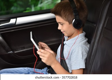 Kid Watching Moving On Tablet Inside Car