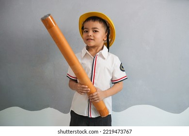 A kid wearing an engineer uniform portraying as a professional contractor. Act like a builder and real estate engineer. - Shutterstock ID 2219473767