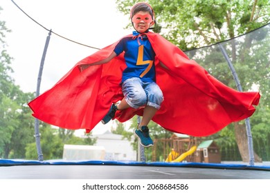 Kid Wearing Superhero Costumes And Having Fun Outdoors