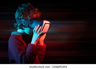 Kid Wearing VR Connected To Metaverse. Innovative Boy Wearing VR Headset Playing Online.