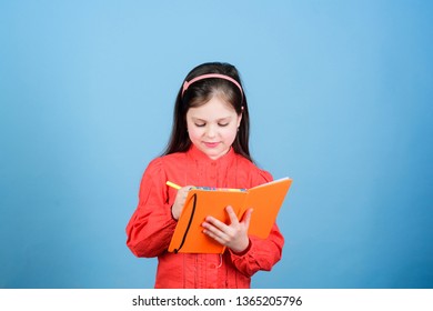 Kid Writing Book. Book Concept. Development Education. Homework Exercise. Write Composition. Literature Club. Personal Diary. Study And Learn. Poetry Author. Girl Hold Book And Pen Blue Background.