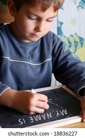 Kid Writing On A Blackboard