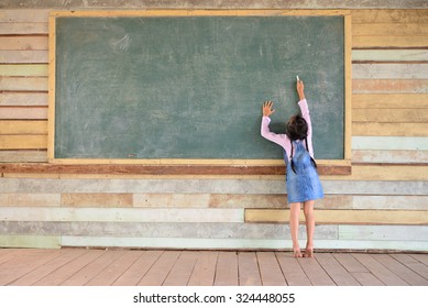 Kid Writing On The Old Green Chalkboard; Old Wood Wall