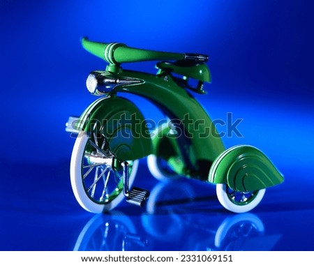 Kiddie Retro Tricycle Green on Blue background sidewalk pedal cruiser