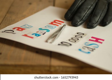 Kidnap Ransom Note With Black Gloved Hand And Tweezers