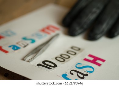 Kidnap Ransom Note With Black Gloved Hand And Tweezers