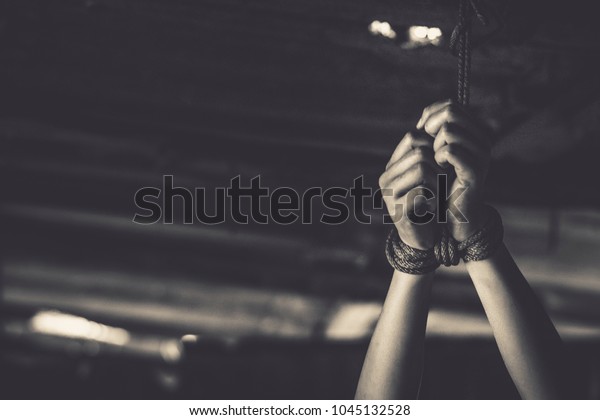 Kidnapped hands with rope,imprisoned in old\
room, trafficking\
Concept.