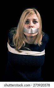 Kidnapped Woman Hostage With Tape Over Mouth And Tied Up With Rope