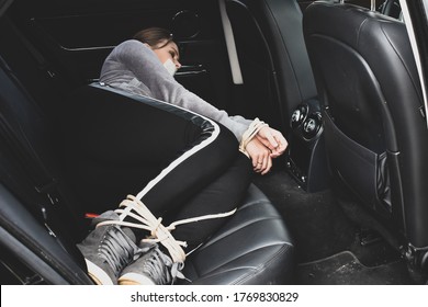 kidnapping. Related woman laying in the car. The trafficking of women. Hands bound the prisoner. Unlawful confinement of a person in captivity. - Shutterstock ID 1769830829