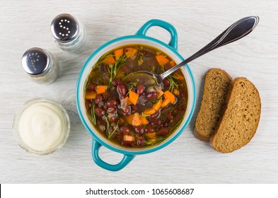 Kidney Bean Soup, Spoon In Bowl, Bowl With Mayonnaise, Pieces Of Bread, Salt, Pepper On Wooden Table. Top View