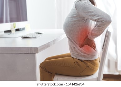 Kidney pain. Sick back in a woman from sedentary work.  - Shutterstock ID 1541426954