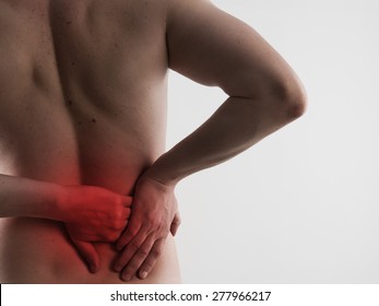 Kidneys ache. Closeup of male back massaging his sore loin or hip. Health care and medicine.  