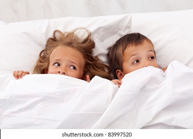 Kids Afraid Laying In Bed And Pulling The Quilt On Their Heads