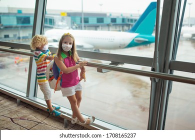 Kids At Airport In Face Mask. Children Look At Airplane After Coronavirus Outbreak. Safe Travel And Flying With Child In Virus Pandemic. Family At Departure Gate. Vacation After Covid-19 Lockdown. 