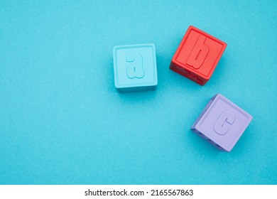 Kids Alphabet Block. Alphabet Block Spelling ABC Isolated On Blue Background.