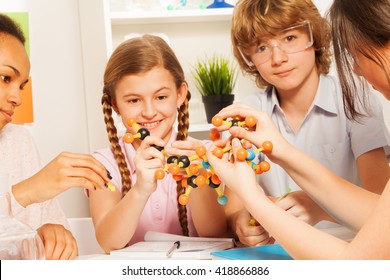 Kids assembling atomic chain with molecular model - Powered by Shutterstock