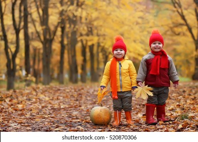 Kids In Autumn Park With Pumpkin Around Fall Leaves