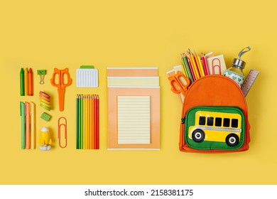 Kids Backpack with school bus on yellow background. Opened School backpack with stationery. Primary School or kindergarten.  - Shutterstock ID 2158381175