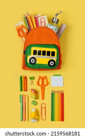Kids Backpack with school bus on yellow background. Opened School backpack with stationery. Primary School or kindergarten.  - Shutterstock ID 2159568181