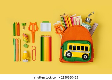 Kids Backpack with school bus on yellow background. Opened School backpack with stationery. Primary School or kindergarten.  - Shutterstock ID 2159880425