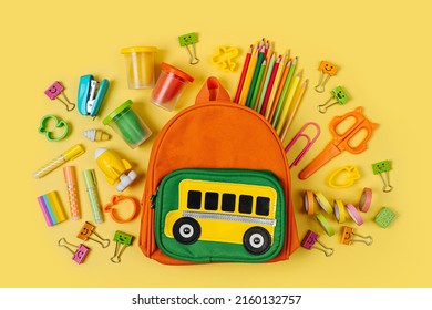 Kids Backpack with school bus on yellow background. Opened School backpack with stationery. Primary School or kindergarten.  - Shutterstock ID 2160132757