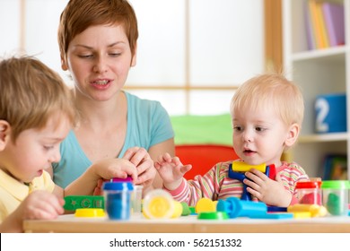 Kids boys playing with play clay at home or kindergarten or playschool
