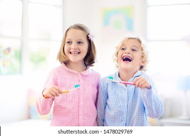 Kids Brush Teeth. Child With Toothpaste. Dental And Oral Hygiene, Care. Healthy Daily Routine After Shower Or Bath At Home. Girl And Boy In Pajamas.