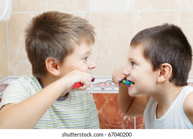 Kids Brushing Teeth In Bathroom Closeup Photo