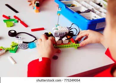 Kids Building Robot At Robotic Technology School Lesson