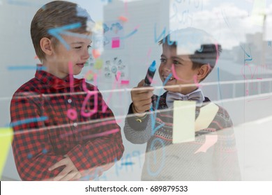 Kids as business executives discussing over whiteboard in office - Powered by Shutterstock