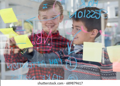 Kids as business executives discussing over whiteboard in office - Powered by Shutterstock