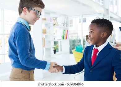 Kids As Business Executives Shaking Hands In Office
