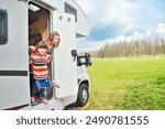 Kids in camper (rv) have fun, family travel in motorhome on holiday vacation trip in camping