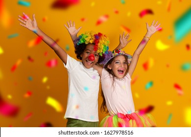 kids celebrating Carnival together at yellow background. Two children celebrating carnival in brazil. 