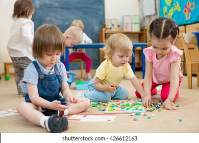 kids or children playing mosaic game in kindergarten room - Shutterstock ID 426612163