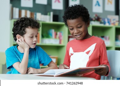 Kids In Classroom, Happy Diverse Boy In Reading Class, American And African Boys Studying Together With Happiness In Elementary School , Kindergarten, Kid Preschool Education Concept