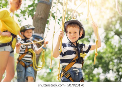 Kids climbing in adventure park in summer camp - Powered by Shutterstock