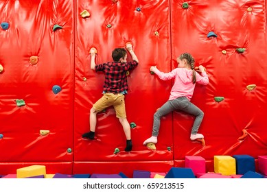 Kids climbing on a wall in attraction playground - Powered by Shutterstock