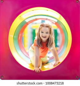 Kids Climbing And Sliding On Outdoor Playground. Children Play In Sunny Summer Park. Activity And Amusement Center In Kindergarten Or School Yard. Child On Colorful Slide. Toddler Kid Outdoors.