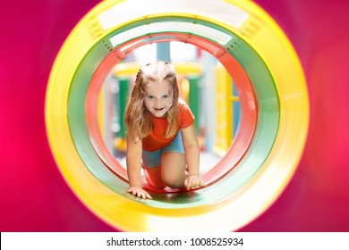 Kids Climbing And Sliding On Outdoor Playground. Children Play In Sunny Summer Park. Activity And Amusement Center In Kindergarten Or School Yard. Child On Colorful Slide. Toddler Kid Outdoors.