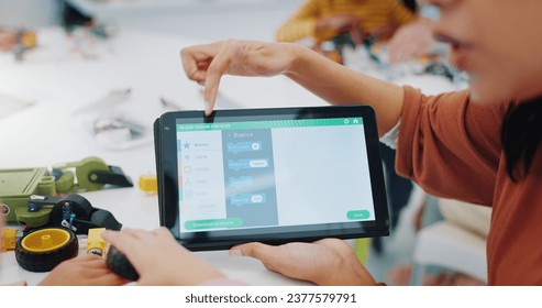 Kids, coding and learning robotics with tablet, screen and engineering app in classroom. Child, hands and show elearning technology with online education game to remote control robot or device - Powered by Shutterstock - Get 15% off with code: PIKWIZARD15
