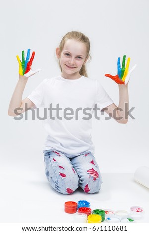 Kids Concepts. Portrait of Funny Young Girl Showing Messy Colorful Hands Brightly Painted During Paint Craft. Against White Background.Vertical Image