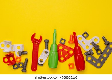 Kids construction tools background with colorful toys plastic bolts, nuts and screwdrivers - Shutterstock ID 788805163