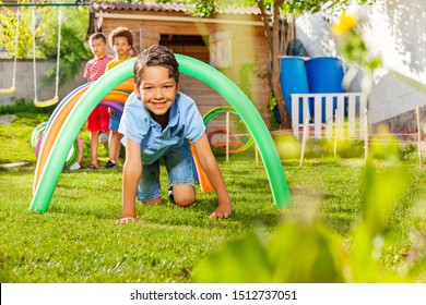 Kids crawl under barriers in a competitive game - Powered by Shutterstock