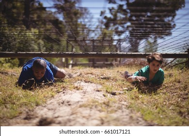 Kids Crawling Under The Net During Obstacle Course In Boot Camp