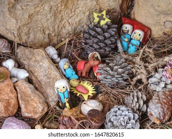 Kids Create Nativity From Plastic Figures And Natural Materials. Hikers Go Around Put There Small Presents.